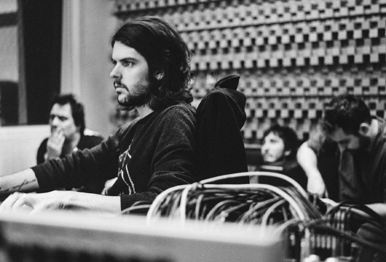 Estanislao López working at a studio using the mix board